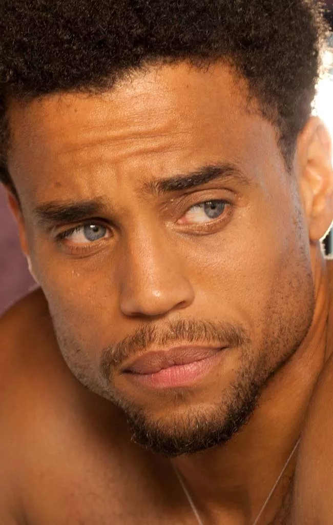blonde african american man with blue eyes looking at camera